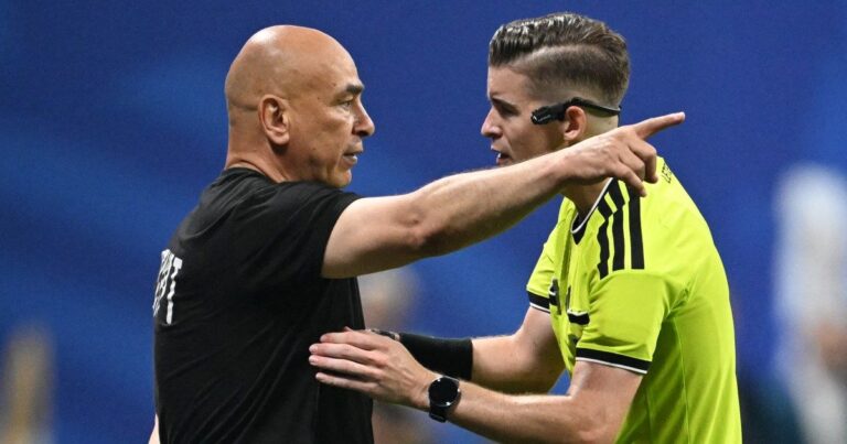 Egyptian coach Hossam Hassan speaking with referee Francois Letexier during the controversial World Cup match against Argentina.