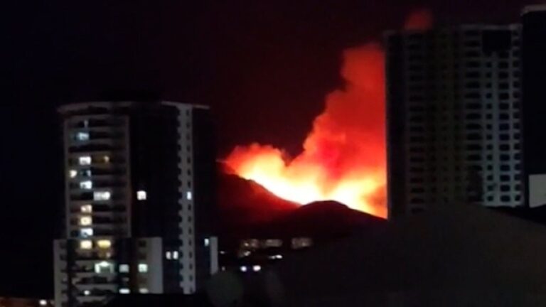 Massive forest fire burning near residential areas in Mamak, Ankara, Turkey, with smoke rising into the sky.