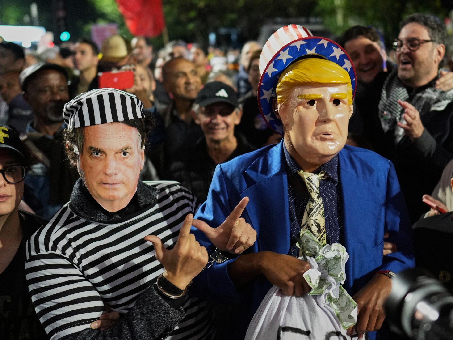 Protesters wearing masks of Donald Trump and Jair Bolsonaro in Sao Paulo, Brazil, demonstrating against perceived political interference.