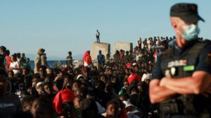 Image depicting border security measures, possibly fences or personnel, at the Ceuta border.