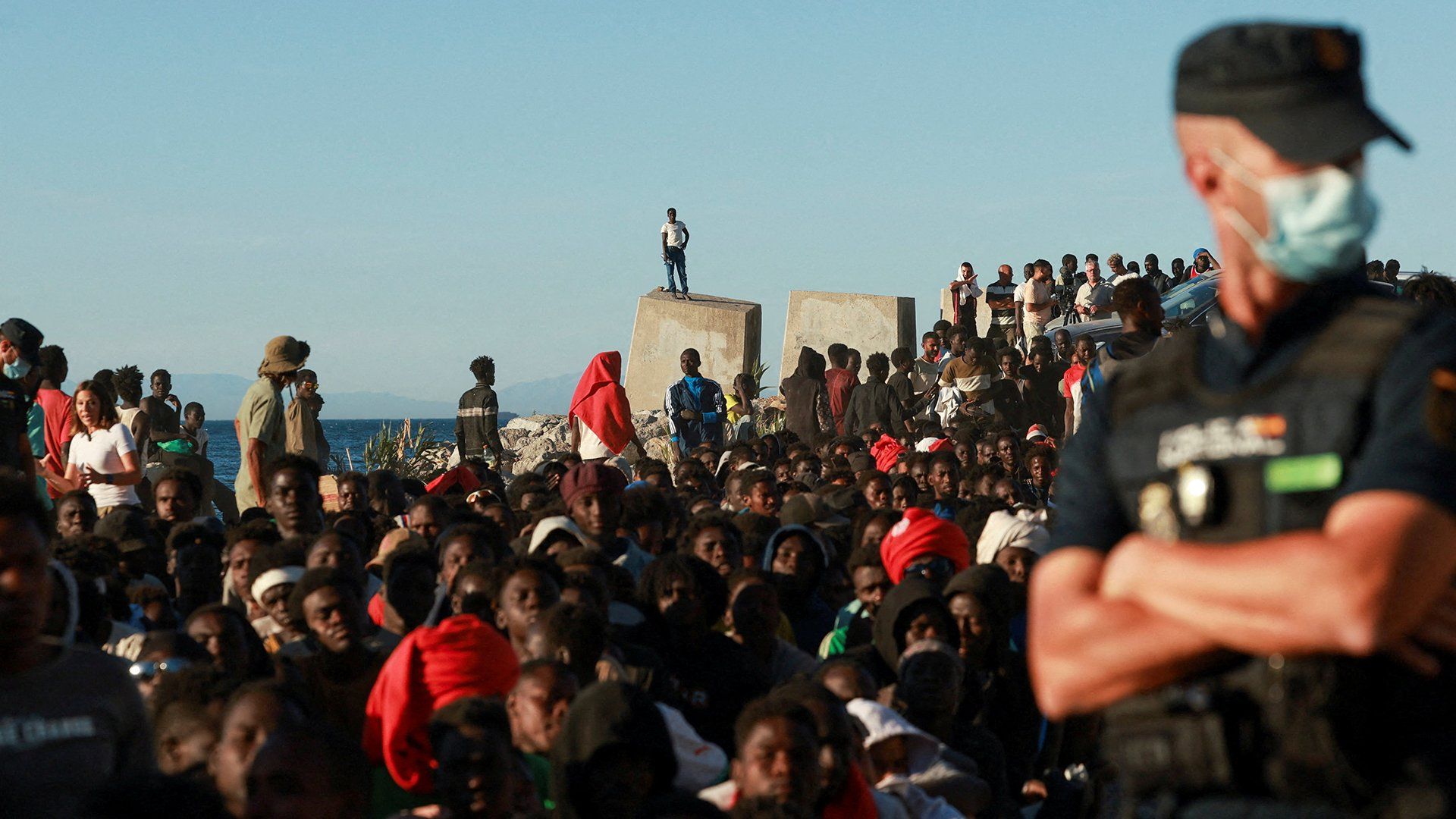 Image depicting border security measures, possibly fences or personnel, at the Ceuta border.