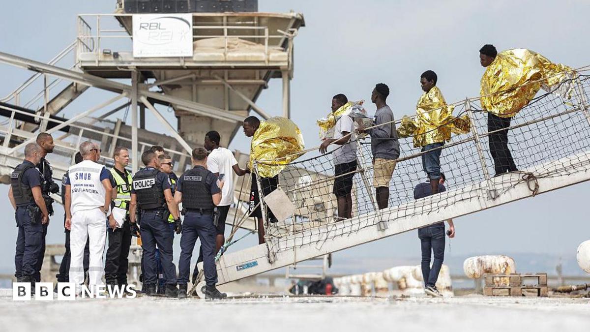 Migrants disembarking from a rescue ship at the Port de Commerce in Boulogne-sur-Mer after a Channel boat fire.
