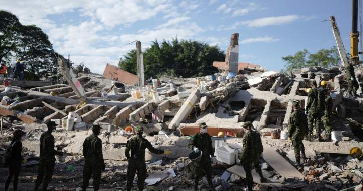 Scene of devastating Colombia earthquake aftermath with rescue workers and rubble.