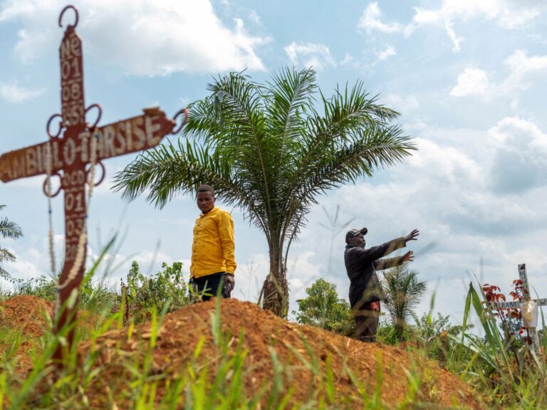 Cemetery supervisor and assistant warden at a gravesite in Ebola-ravaged Mungwalu, Ituri province, northeastern Democratic Republic of Congo.