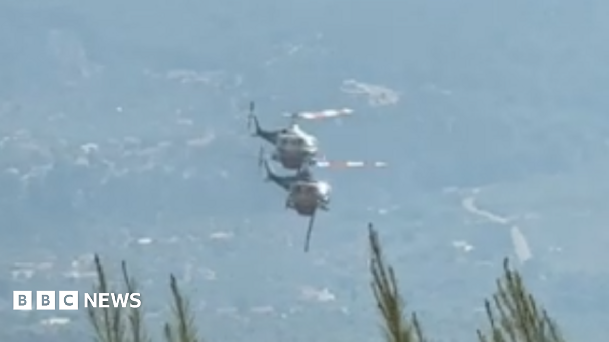 Two crew members died in a devastating Greece helicopter collision while battling wildfires near Athens. A British pilot survived the mid-air crash. All Bell helicopters grounded.