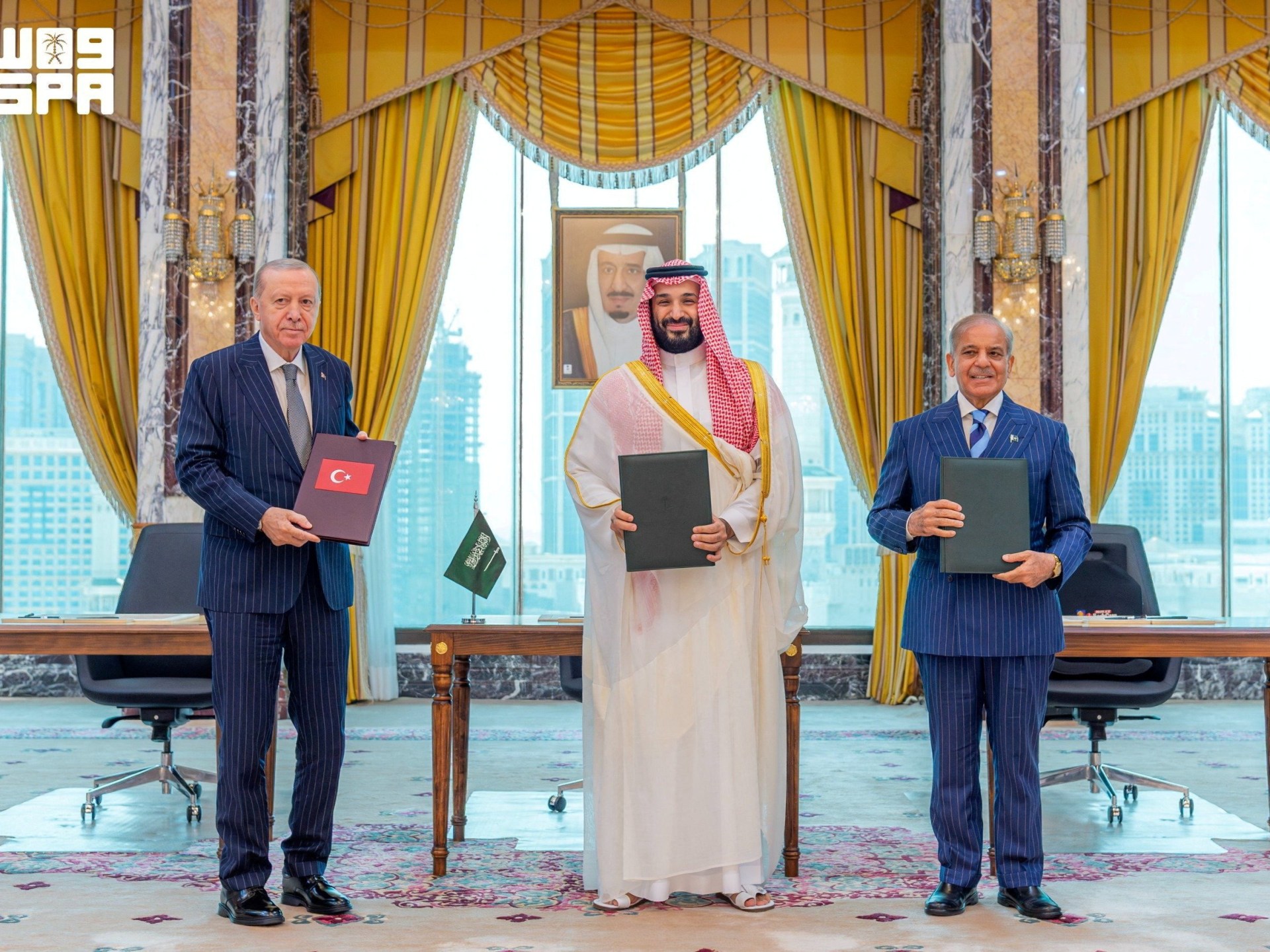 Turkish President Tayyip Erdogan, Saudi Crown Prince Mohammed bin Salman, and Pakistan's Prime Minister Shehbaz Sharif pose after signing a joint defence agreement.