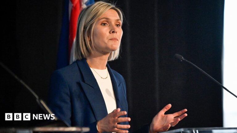 Iceland's Prime Minister Kristrún Frostadóttir delivering a speech at a lectern.