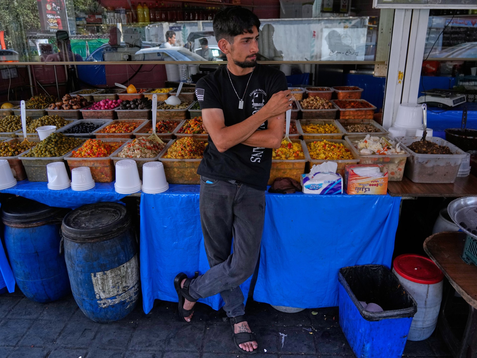 A shopkeeper waits for customers in Tehran, Iran amidst economic struggles.