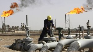 Iraqi worker maintaining an oil pipe at Nahr al-Umran gas refinery in Iraq