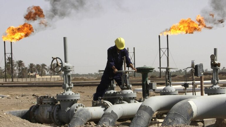 Iraqi worker maintaining an oil pipe at Nahr al-Umran gas refinery in Iraq