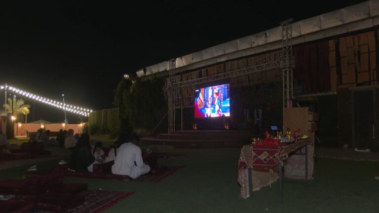 Families gather at an open-air cinema in Khartoum, finding an escape from war amidst challenges like power outages.
