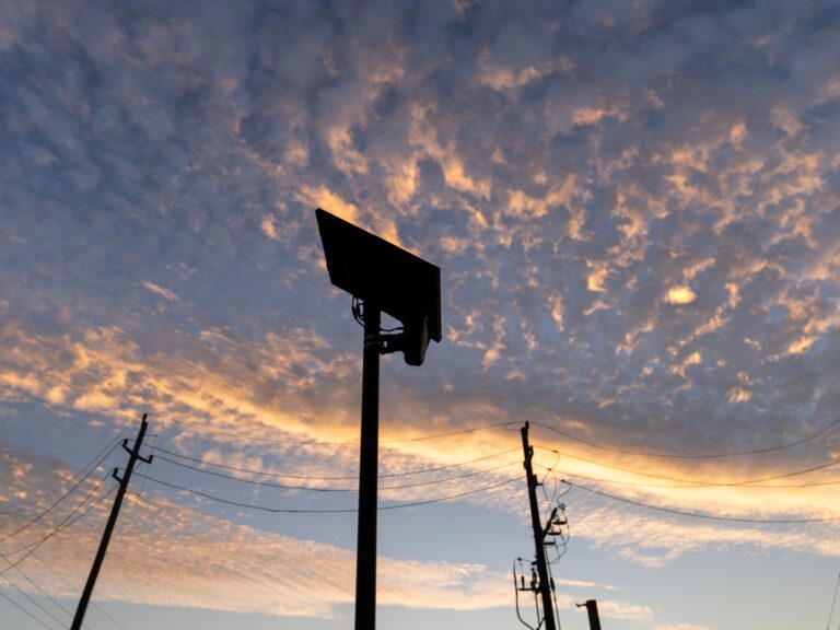 A Flock Safety licence plate reader mounted by a public road in Houston, Texas.