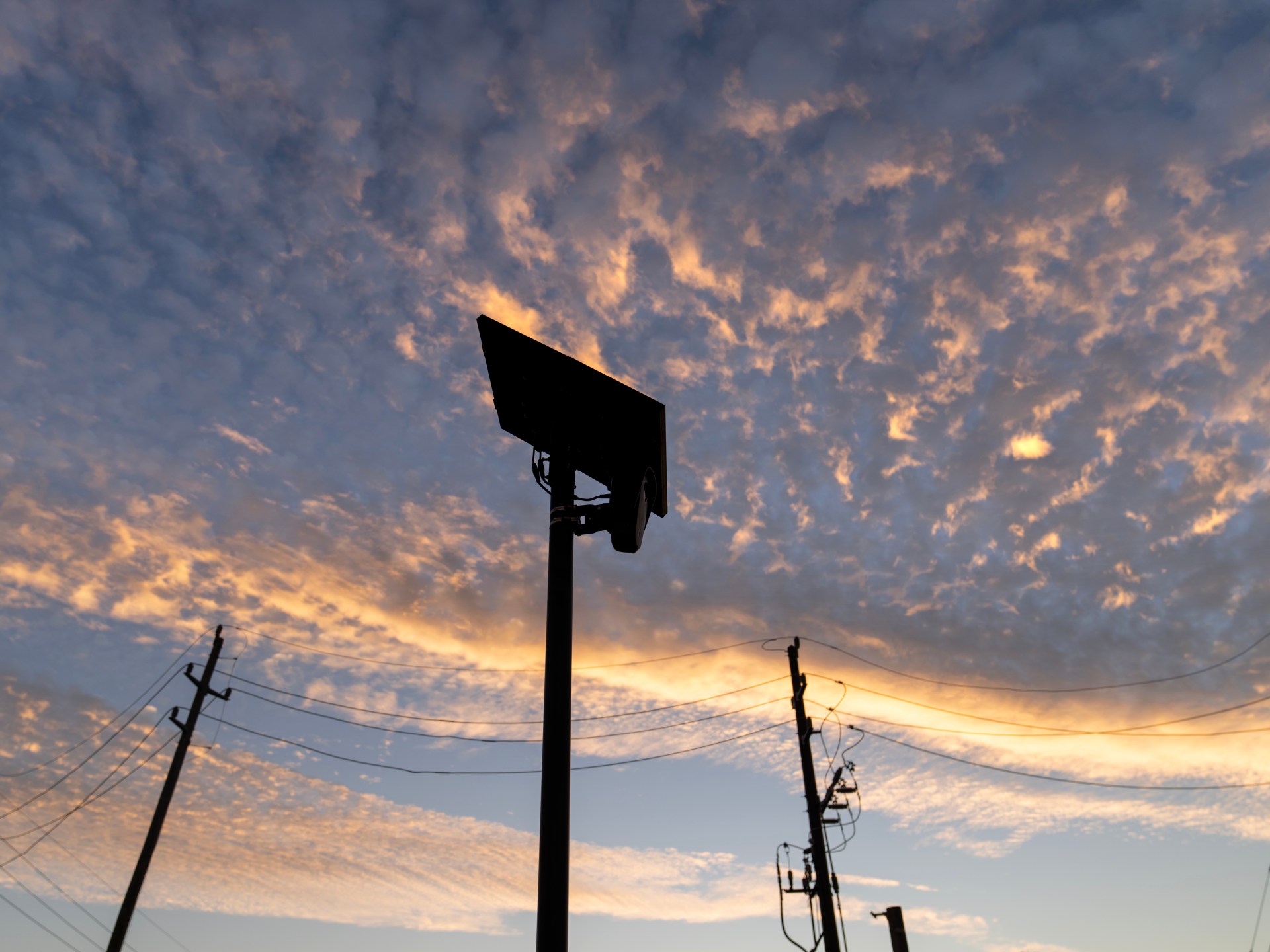 A Flock Safety licence plate reader mounted by a public road in Houston, Texas.