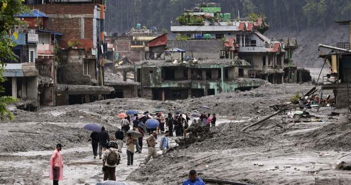 Rescue workers search through mud and debris after catastrophic Nepal floods, highlighting the ongoing search for missing individuals.