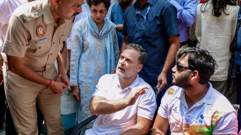 Rahul Gandhi sits with 19-year-old pellet victim Sahil Lochab during a protest at the Parliament Street police station in New Delhi.