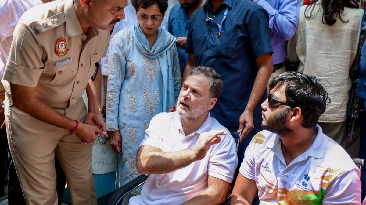 Rahul Gandhi sits with 19-year-old pellet victim Sahil Lochab during a protest at the Parliament Street police station in New Delhi.
