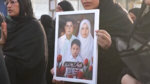 Funeral in Iran for a family killed in a US strike on Qeshm Island, highlighting the tragic human cost and escalating tensions.