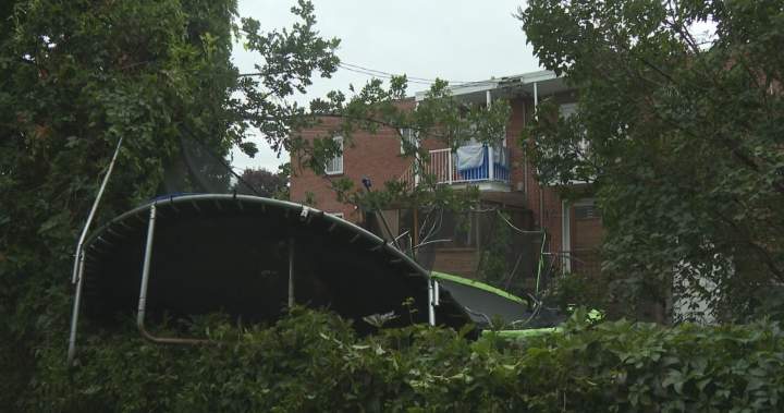 A damaged trampoline tangled in tree branches after a severe storm in Repentigny, Quebec, under investigation for a possible tornado.