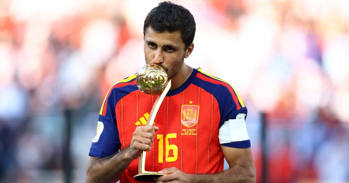 Rodri celebrates a goal while playing for Manchester City. Image shows him with his arms outstretched.
