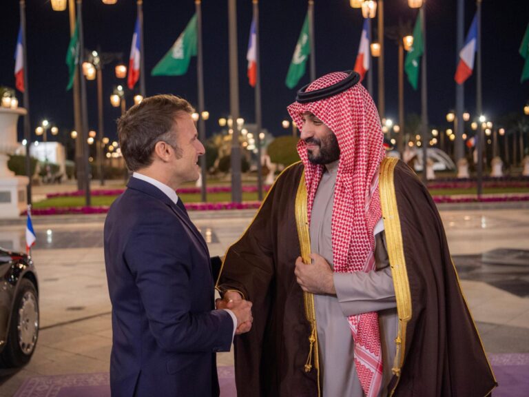 French President Emmanuel Macron and Saudi Crown Prince Mohammed bin Salman shaking hands at a formal meeting.