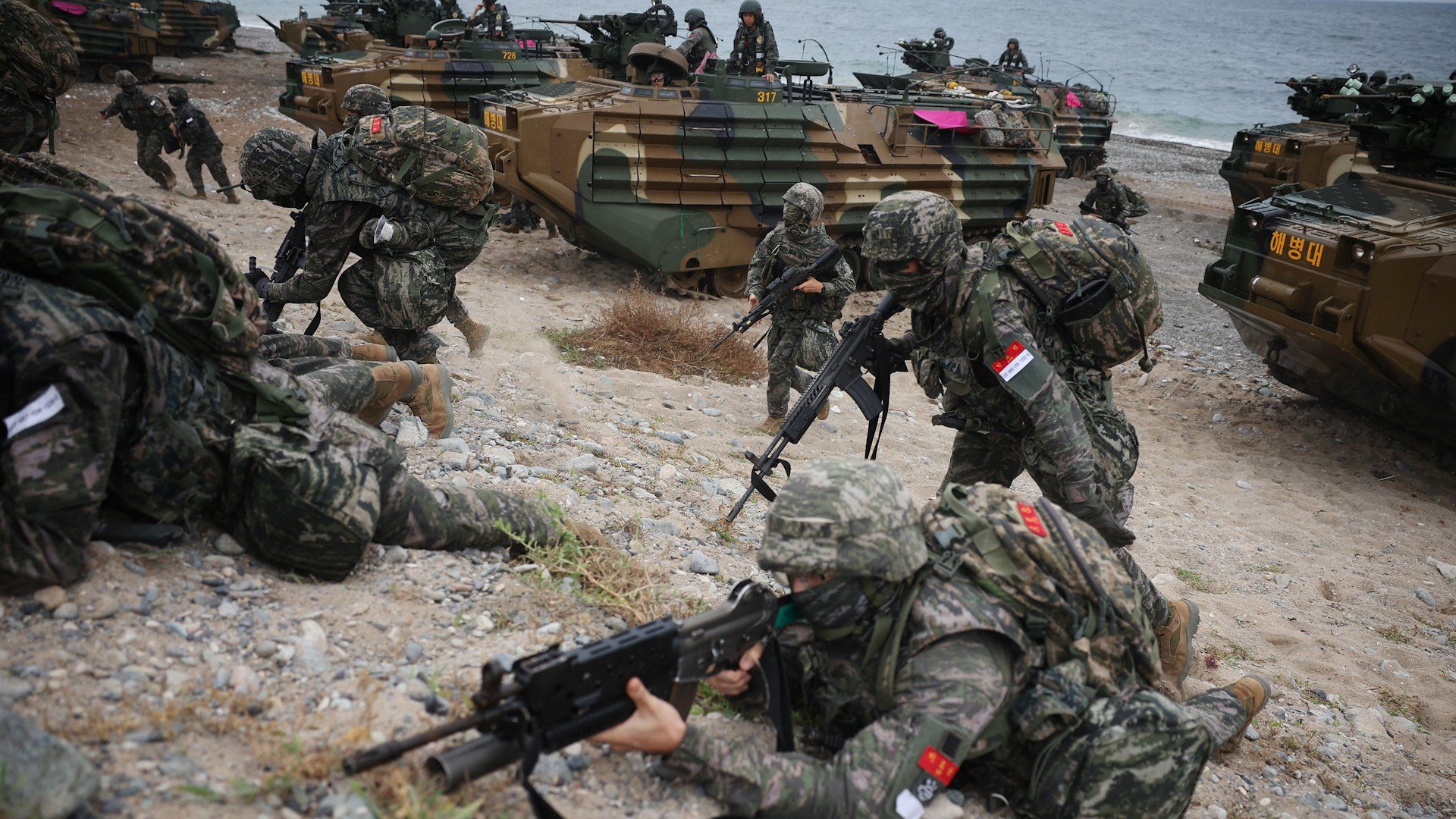 Image showing military activity or diplomatic figures, illustrating the context of scaled-back US-South Korea military exercises.