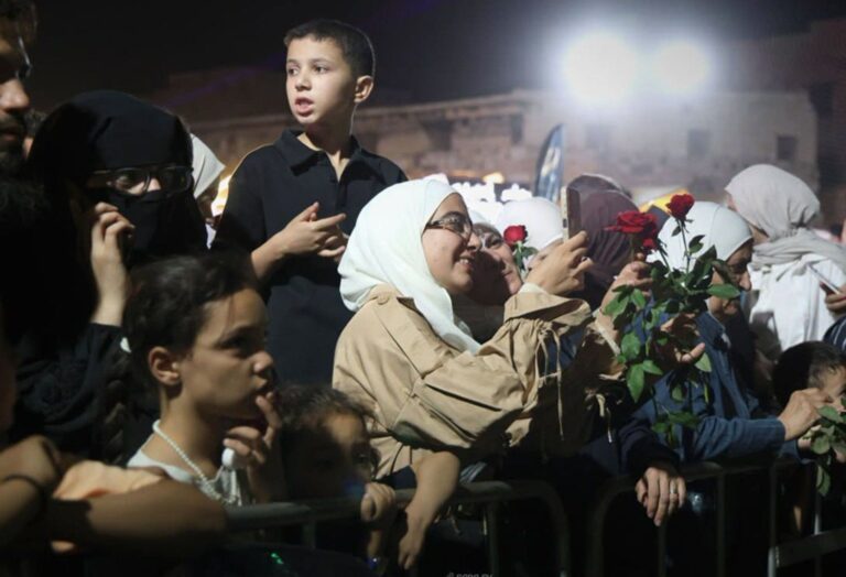 Syrian army helicopters dropping roses over a festival crowd at Damascus Citadel, symbolizing a new era of peace and cultural revival in Syria.