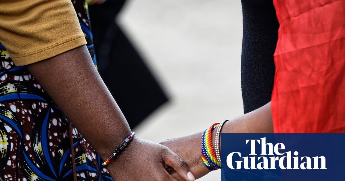 Image of two LGBTQ+ activists holding hands in Kenya after a court hearing, representing the struggle for rights in Africa.