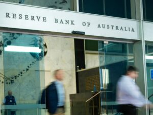 A photograph showing people exiting the Reserve Bank of Australia building as interest rate hikes impact the economy.