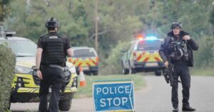 Police presence and bomb disposal robots at the scene of explosives arrests near RAF Fairford.