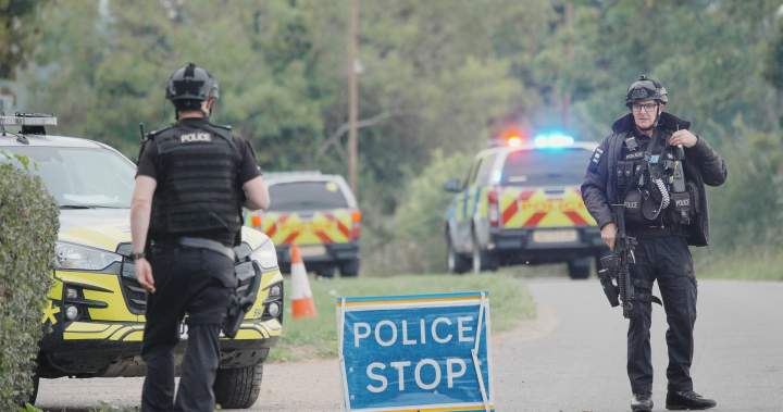 Police presence and bomb disposal robots at the scene of explosives arrests near RAF Fairford.