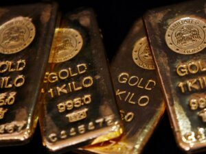 A close-up of gold bars representing the recent drop in gold prices due to a strengthening US dollar.
