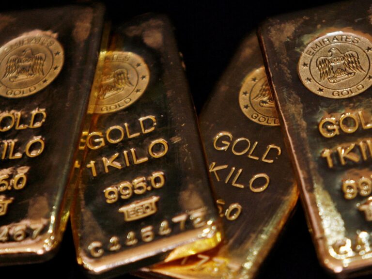 A close-up of gold bars representing the recent drop in gold prices due to a strengthening US dollar.