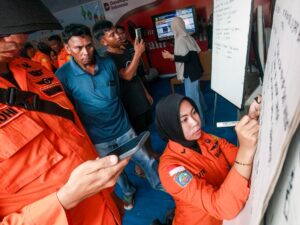 Relatives await news of passengers from the missing Virgo Transport 8 ferry in Banjarmasin, South Kalimantan, Indonesia, after a disaster in the Java Sea.