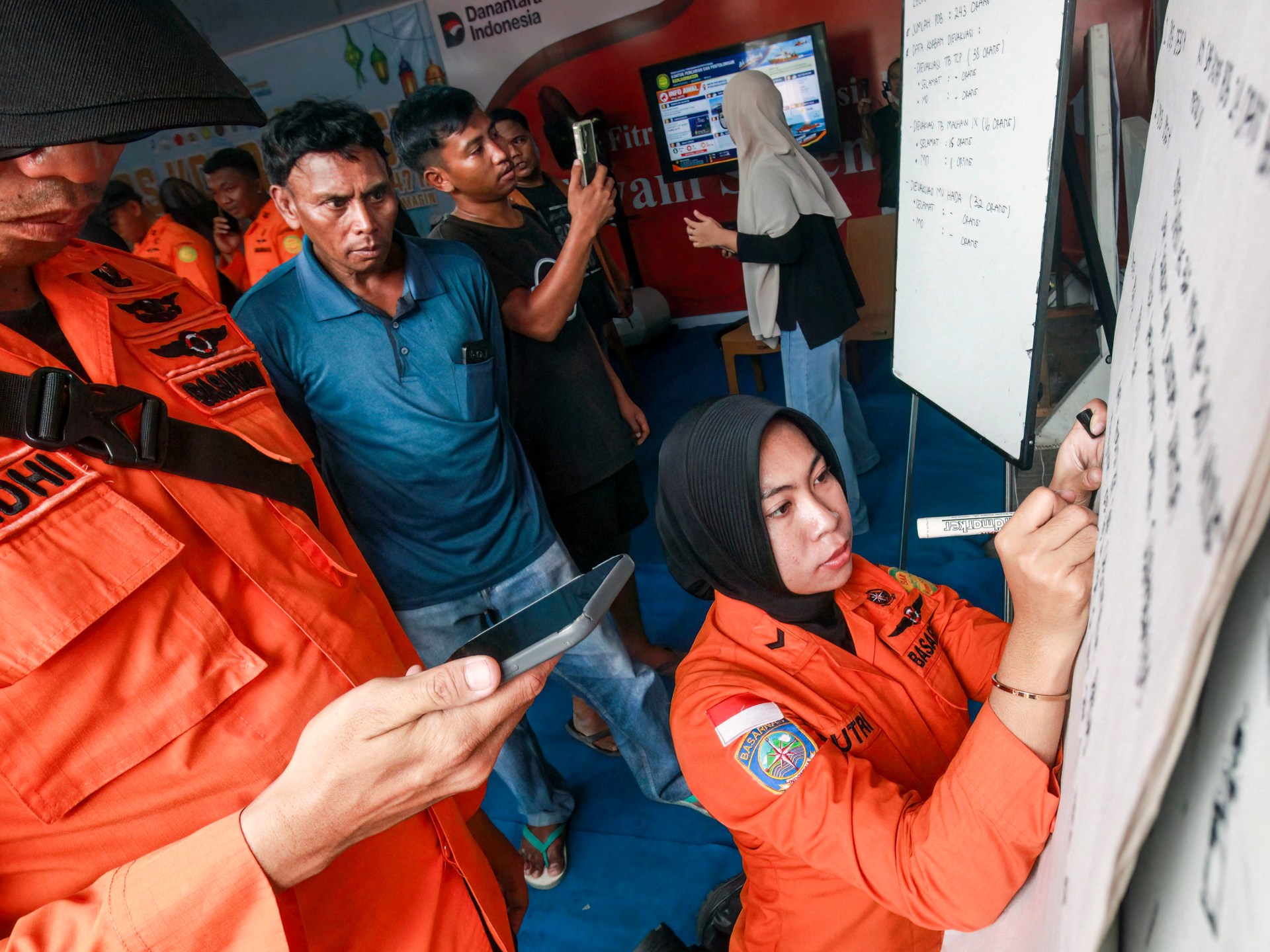 Relatives await news of passengers from the missing Virgo Transport 8 ferry in Banjarmasin, South Kalimantan, Indonesia, after a disaster in the Java Sea.