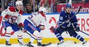 Gavin McKenna and Kirill Marchenko skating during their first game for the Toronto Maple Leafs at Scotiabank Arena.
