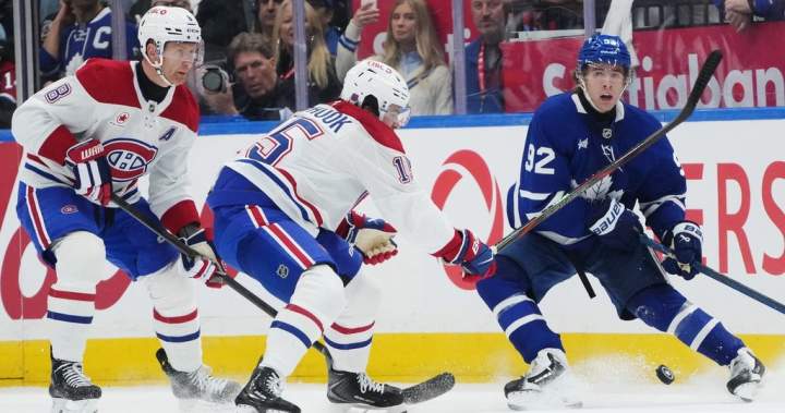 Gavin McKenna and Kirill Marchenko skating during their first game for the Toronto Maple Leafs at Scotiabank Arena.