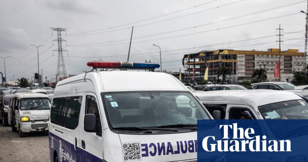 Ambulance stuck in traffic in Lagos, Nigeria, highlighting transport challenges during a health crisis.
