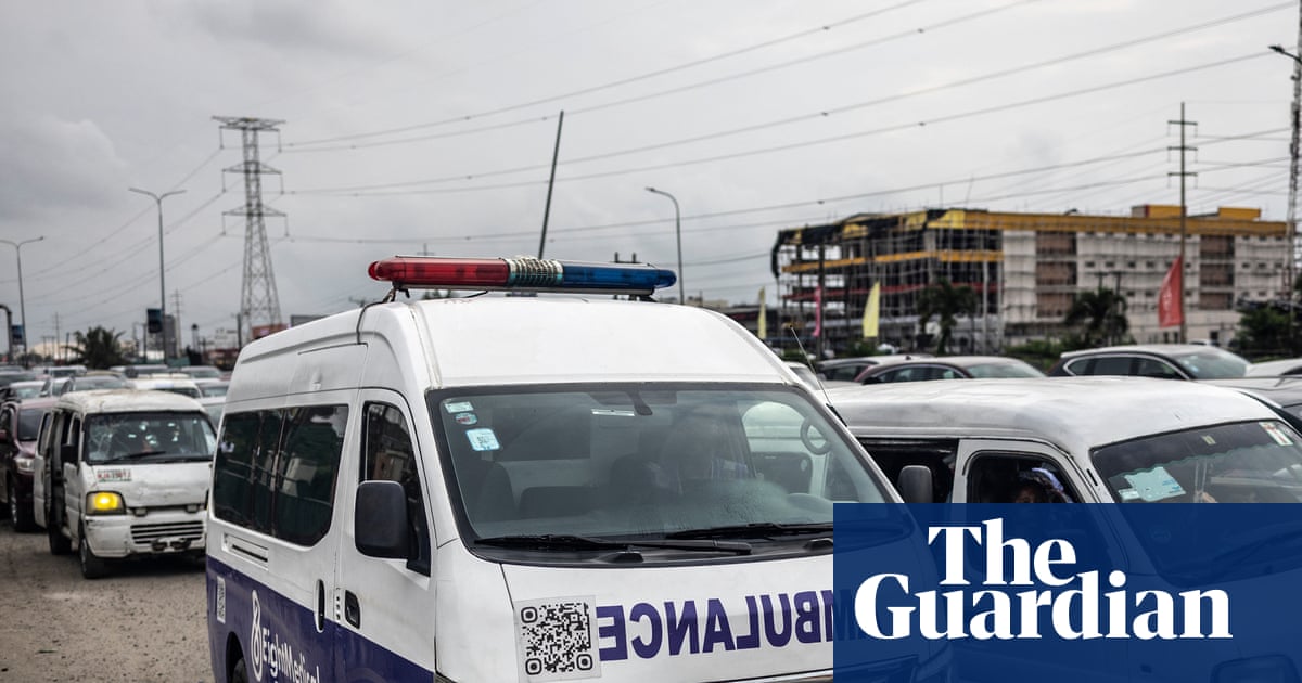 Ambulance stuck in traffic in Lagos, Nigeria, highlighting transport challenges during a health crisis.