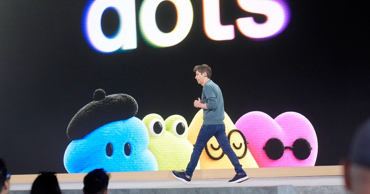A photograph showing Sam Altman at the OpenAI DevDay conference discussing new AI initiatives.