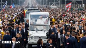 Pope Leo XIV waves to a massive crowd on the Champs-Élysées during his historic visit to Paris.