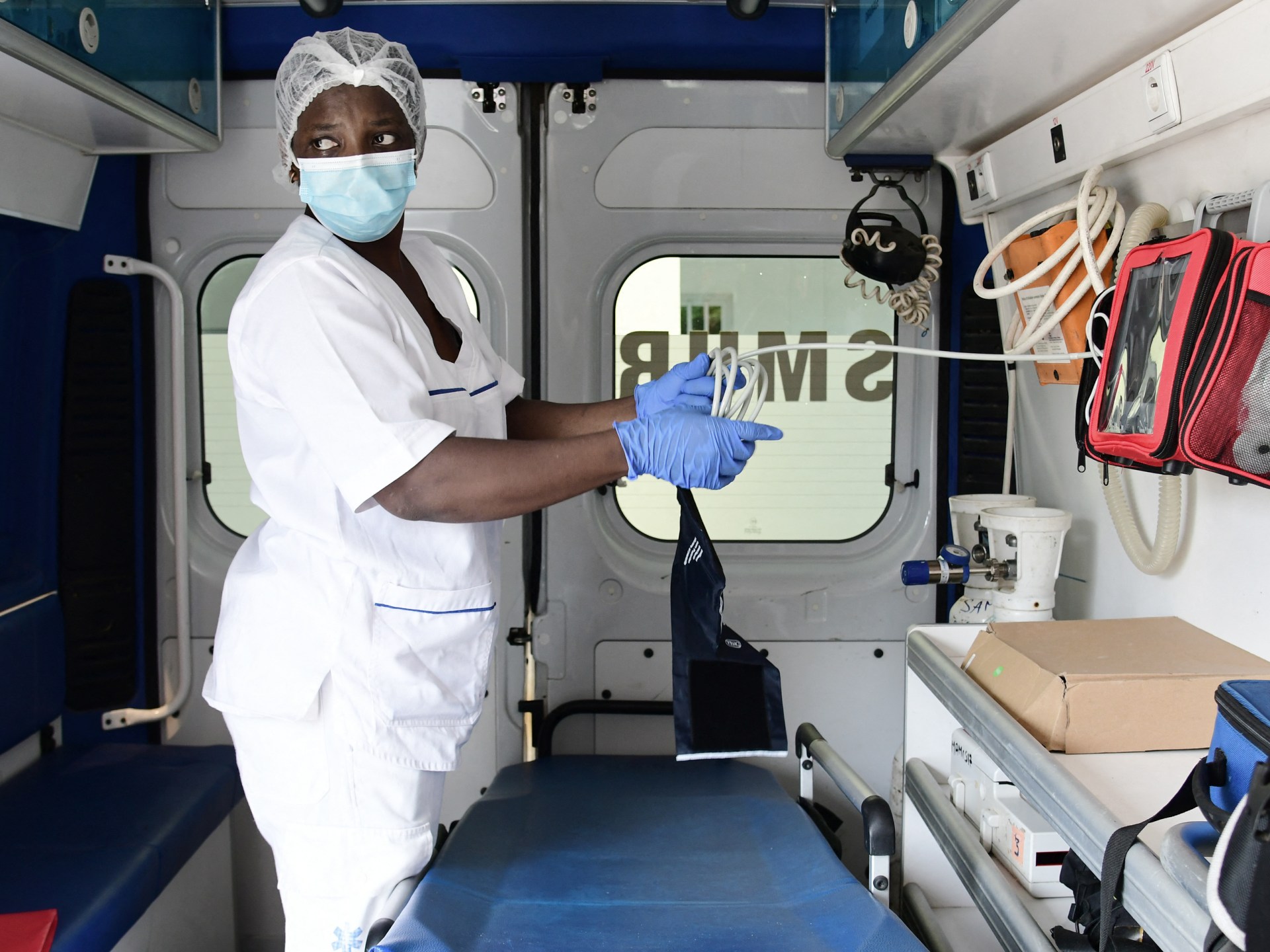 A nurse preparing equipment inside an ambulance in Dakar, highlighting the challenges within the local medical infrastructure.