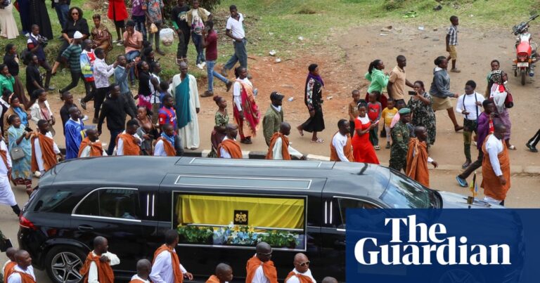Royal guards escorting the coffin of King Oyo through the streets of Fort Portal, Uganda, for burial at Karambi Royal Tombs.
