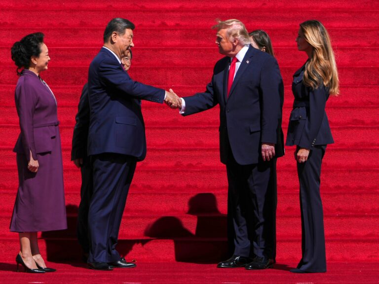 Presidents Trump and Xi shaking hands during their recent summit.