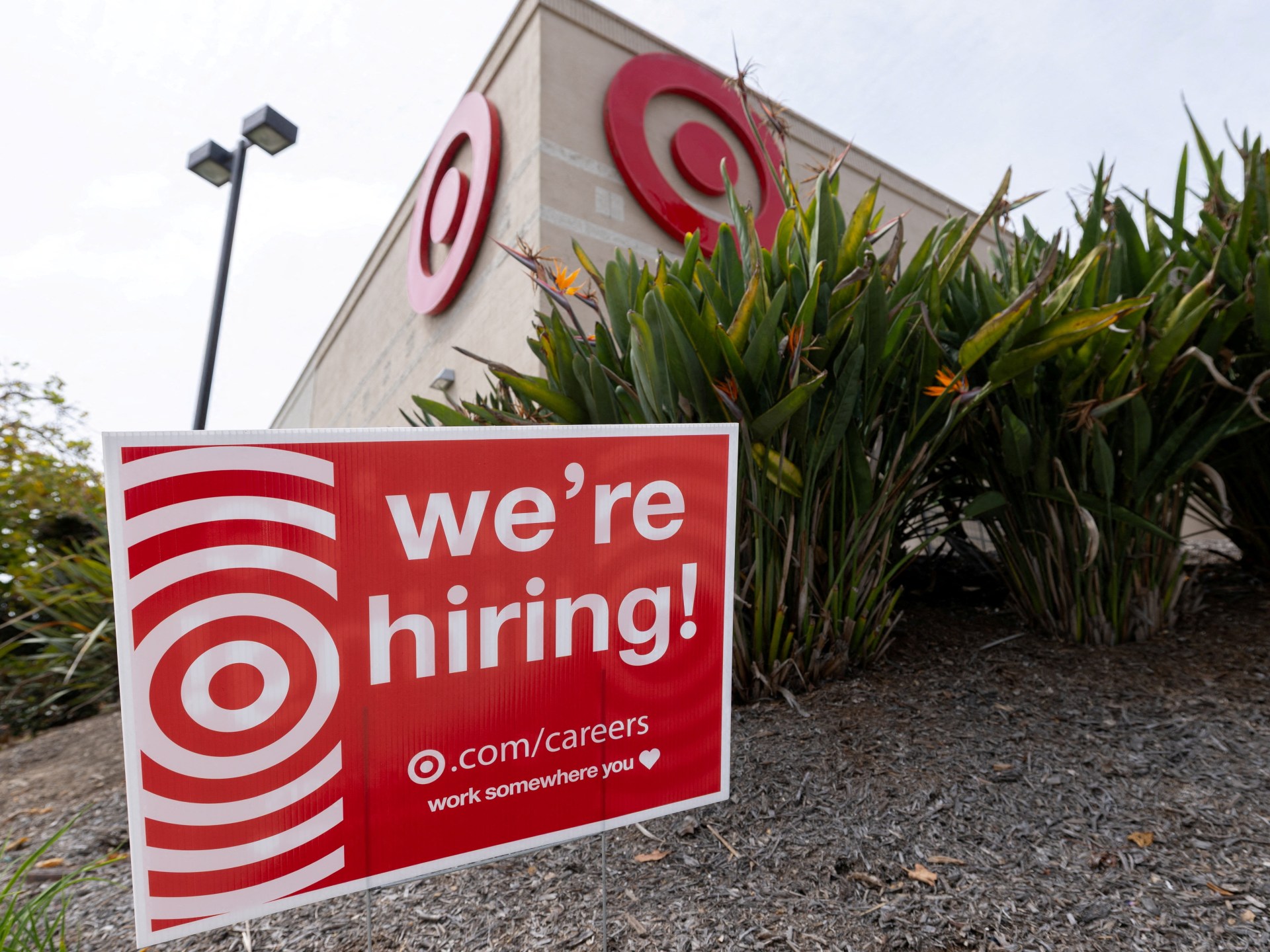 Sign outside a Target store indicating hiring, reflecting US job growth.