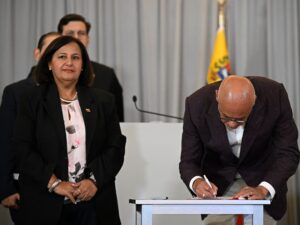 Representatives from the Venezuelan government and opposition sign a new agreement for judicial reform in Caracas.