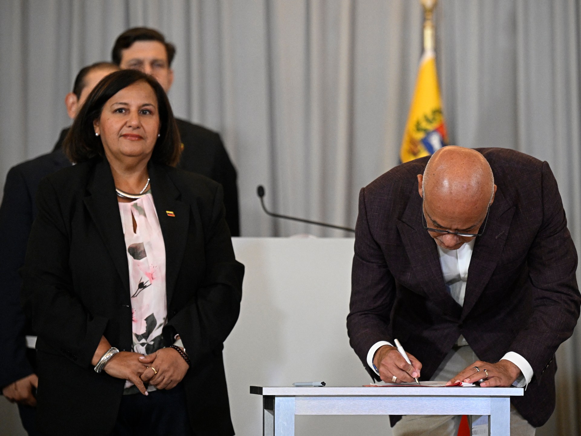 Representatives from the Venezuelan government and opposition sign a new agreement for judicial reform in Caracas.