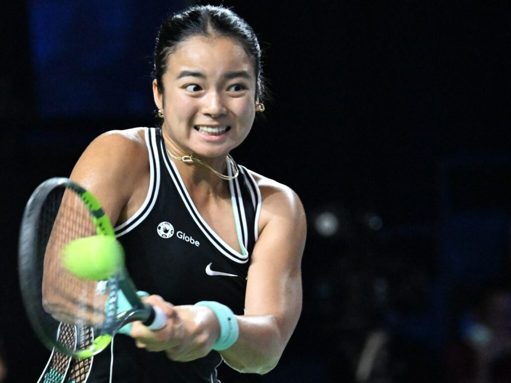 Alex Eala competing in a professional tennis match during the Asian Games.