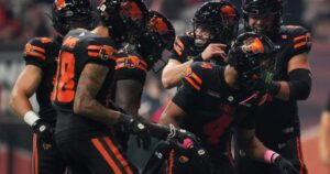 Value: Quarterback Nathan Rourke celebrates with teammates after a key touchdown that secured the BC Lions a playoff spot.