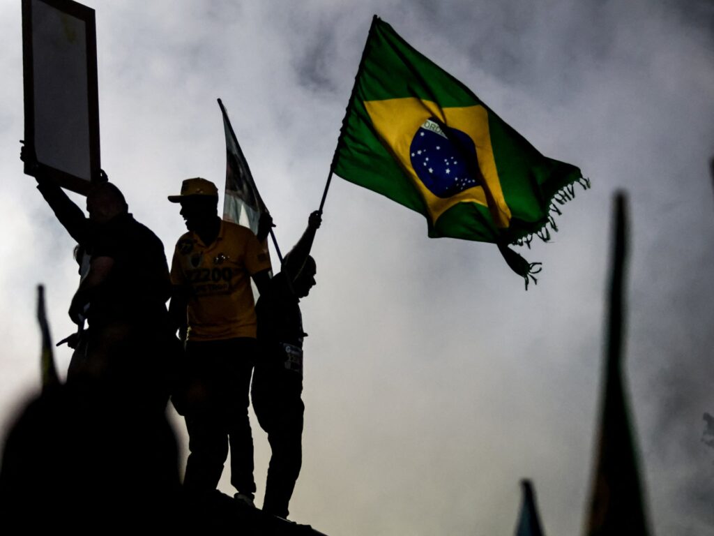 Voters waiting in line at a polling station during the tense 2026 Brazil election between Lula and Flavio Bolsonaro.
