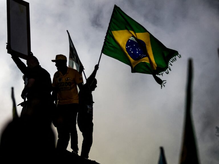 Voters waiting in line at a polling station during the tense 2026 Brazil election between Lula and Flavio Bolsonaro.